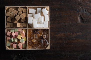 different types of sugar on wooden background