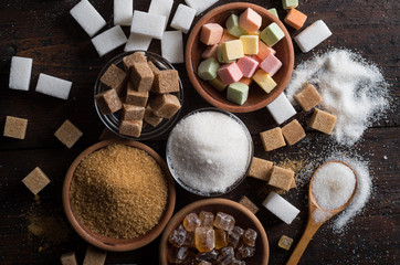 different types of sugar on wooden background