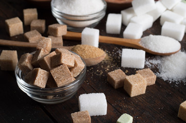 different types of sugar on wooden background