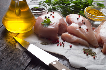 Raw chicken meat on wooden board on table