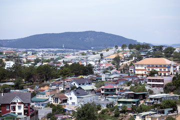 Fototapeta na wymiar Top view Dalat city with bluesky and clouds in the hill, Dalat Vietnam. Vacation, holiday concept.