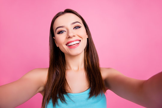 I'm on live broadcasting! Close up portrait of funny beautiful adorable pretty sweet lovely gentle with beaming smile girl taking a selfie, isolated on pink background