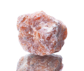 macro shooting of natural mineral rock specimen -  Raw orange Calcite stone on an isolated white background,reflection
