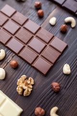 Delicious variety of chocolate on wooden background