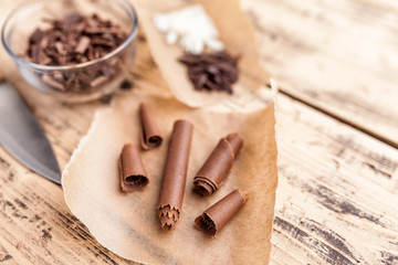 Delicious chocolate swirls on wooden background