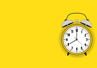 Yellow color vintage alarm clock, wake up time, isolated on yellow background,