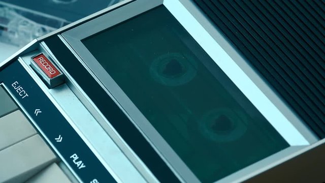 Retro technology concept, tape rolling in audio cassette player 