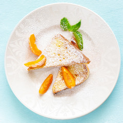 French toasts with fresh cut apricot, mint and icing powder. Healthy classic breakfast concept. Top view. Square image.