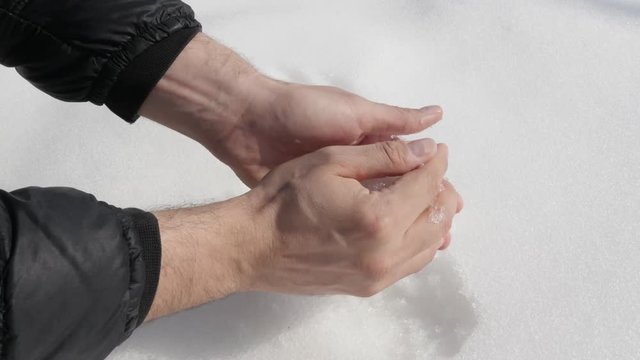 Round snowball in the hands footage - Taking and shaping snow
