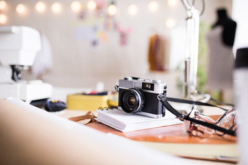A camera on a table in interior of a studio, startup business.