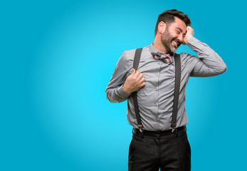 Middle age man, with beard and bow tie confident and happy with a big natural smile laughing