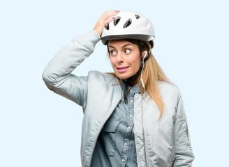 Young woman with bike helmet and earphones doubt expression, confuse and wonder concept, uncertain future