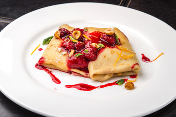 Pancake with raspberry and syrup