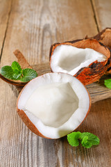 Coconut with mint on old wooden table. Organic healthy food concept.Beauty and SPA concept.