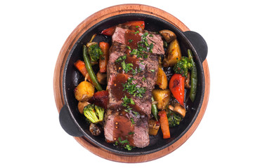 Hot metal pan with roast beef and vegetables