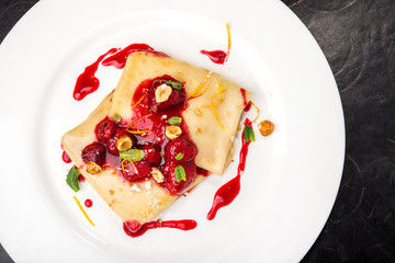 Pancake with raspberry and syrup
