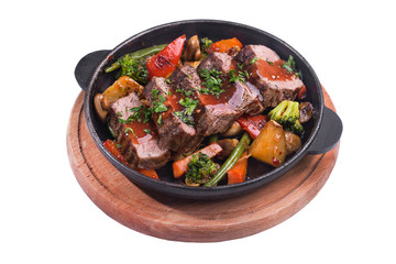 Hot metal pan with roast beef and vegetables