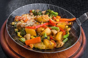 Hot metal pan with potatoes, meat