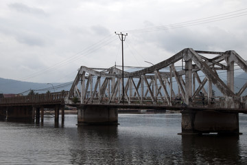 Kampot Cambodia, old bridge across river used by pedestrians and bikes