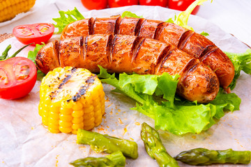 grilled krakauer sausage with boiled corn and green salad