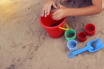 Fototapeta na wymiar child playing with toys on the beach