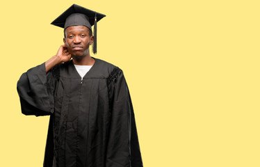 Young african graduate student black man doubt expression, confuse and wonder concept, uncertain future