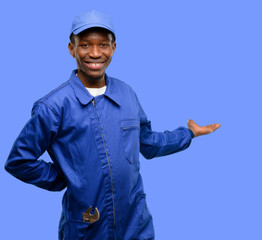 African black plumber man confident and happy with a big natural smile inviting to enter