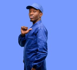 African black plumber man proud, excited and arrogant, pointing with victory face