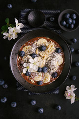 Smoothie bowl for breakfast on dark background