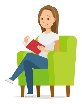 A long hair young woman is reading on a sofa