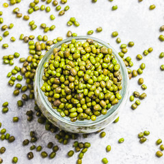 Mung beans in glass jar on concrete background. Top view, space for text.