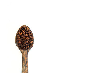 Coffee Beans in wooden spoon on white.