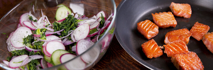 Grilled salmon with radish and spinach, served on wooden table. View from above, top studio shot