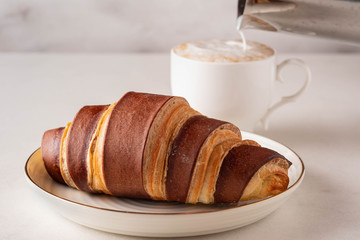 Fresh croissants. French pastries. Breakfast with croissants and tea, coffee.