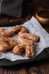 Traditional churros Spanish homemade sweet dessert pastry food on vintage wooden table background.