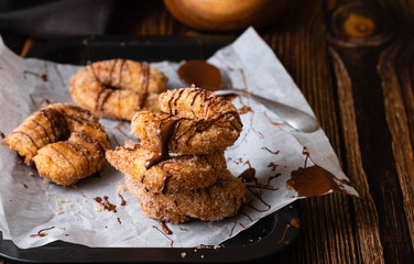 Traditional churros Spanish homemade sweet dessert pastry food on vintage wooden table background.
