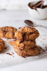 Churros with sugar and chocolate sauce on a white background.
