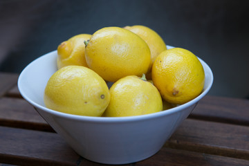 fresh yellow lemons on the wooden table