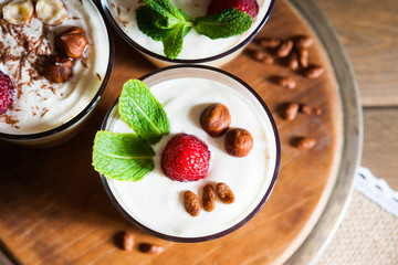 Dessert with berries, jelly, cream, nuts and mint leaf 