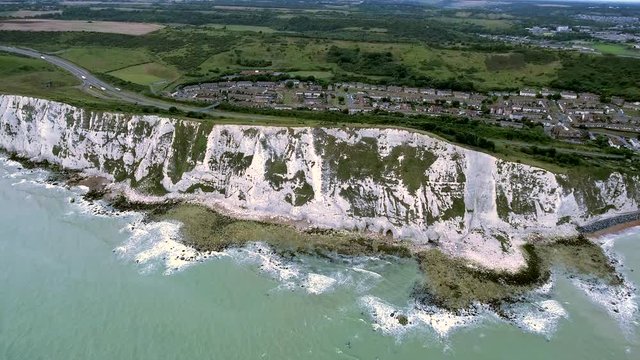 4K Aerial View Drone Shot Waves Lap Towards the Coast of the White Cliffs of Dover Nature Landscape in South East England