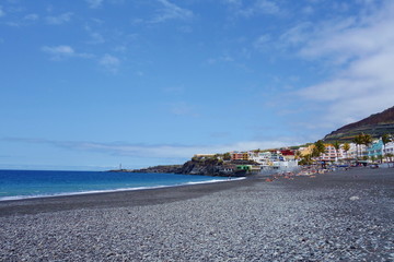 Fototapeta na wymiar Black lava sand beach in Puerto Naos located near to Los Llanos in Canary Islands, Spain