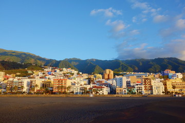 Fototapeta na wymiar Colorful sunrise on the beach overlooking the capital city Santa Cruz de la Palma together with the mountains, Canary Islands, Spain