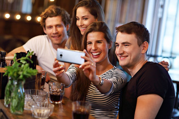 Group Of Friends Enjoying Meal In Restaurant