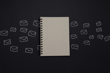 Notepad and Envelopes on a Dark Background. Concept of writing a letter