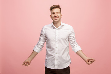 Fototapeta na wymiar The happy business man standing and smiling against pink background.