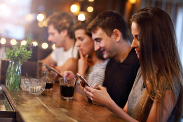 Group Of Friends Enjoying Meal In Restaurant