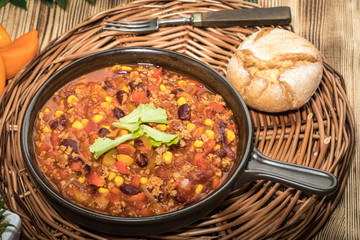 Chili con carne in a clay pan.