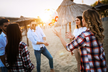 Friends partying and having fun on beach at summer