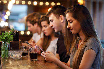 Group Of Friends Enjoying Meal In Restaurant