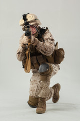 Soldier in camouflage holding rifle